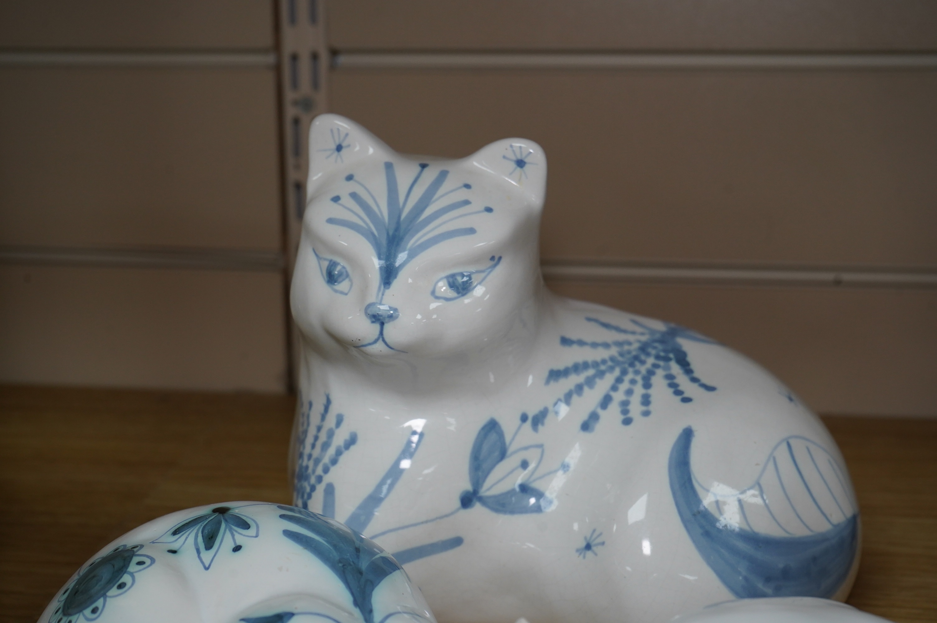 Three large David Sharp Rye pottery models of cats and a Moments by Coalport cat ‘Mothers Love’, tallest 18cm. Condition - largest cat with large firing crack to base otherwise good